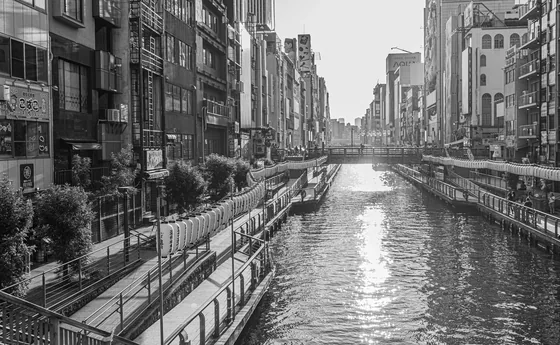 The same canal in black and white, signage stacked to the sky